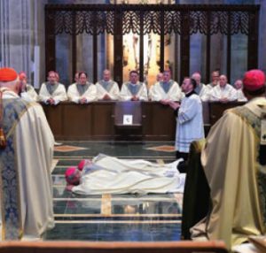 Auxiliary Bishops Adam J. Parker and Mark E. Brennan lay prostrate during their Jan. 19 ordination Mass at the Cathedral of Mary Our Queen in Baltimore